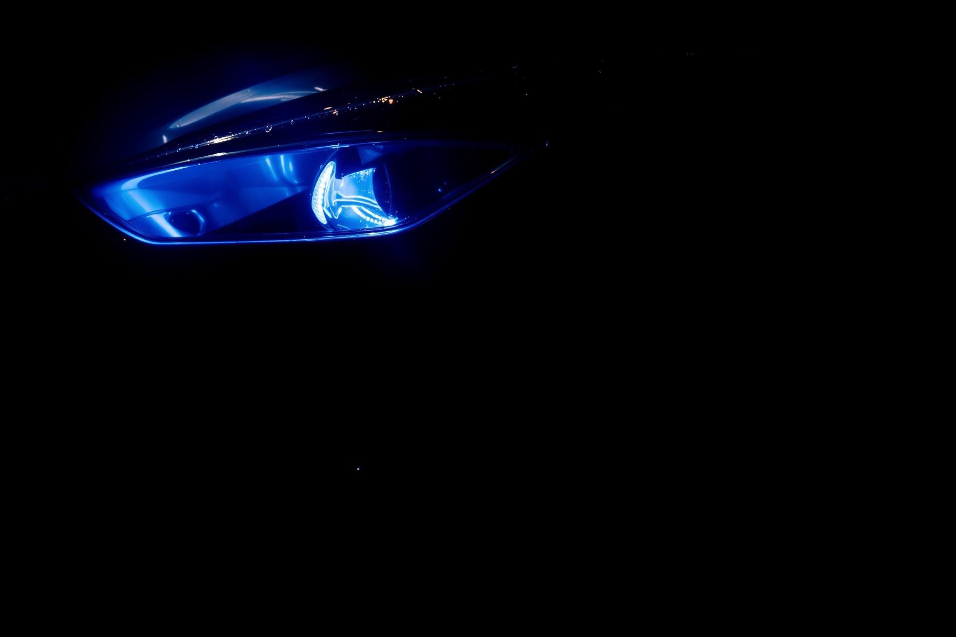 Glossy black luxury car detailed at night